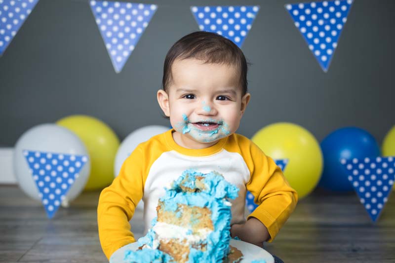 image of a young child enjoying a smash cake at the photography studio of TK Photography Chicago