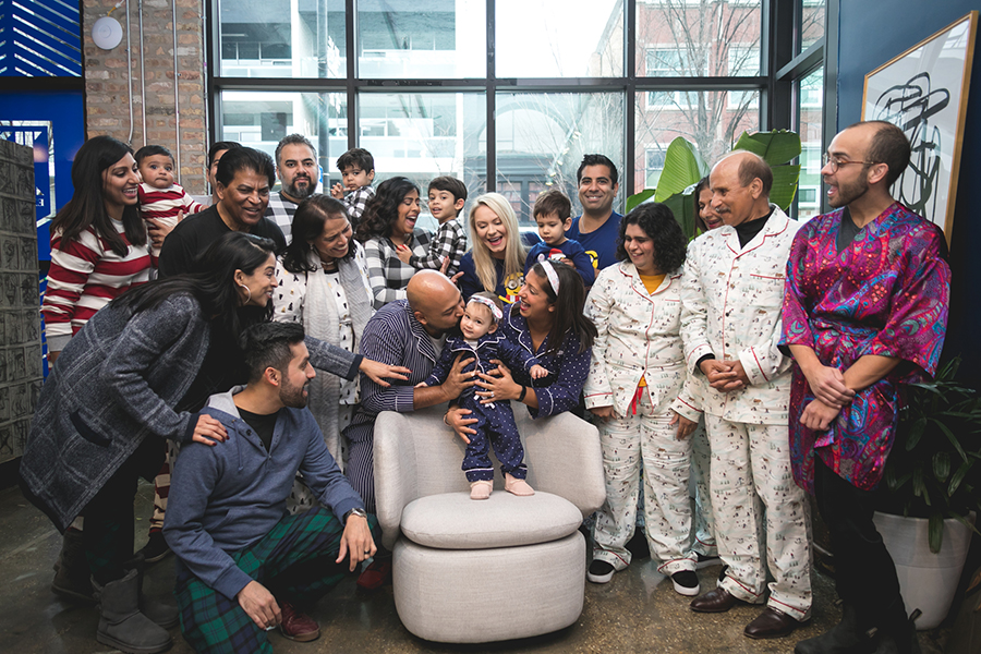 Family gathering around the birthday girl at a party Photographed by TK Photography