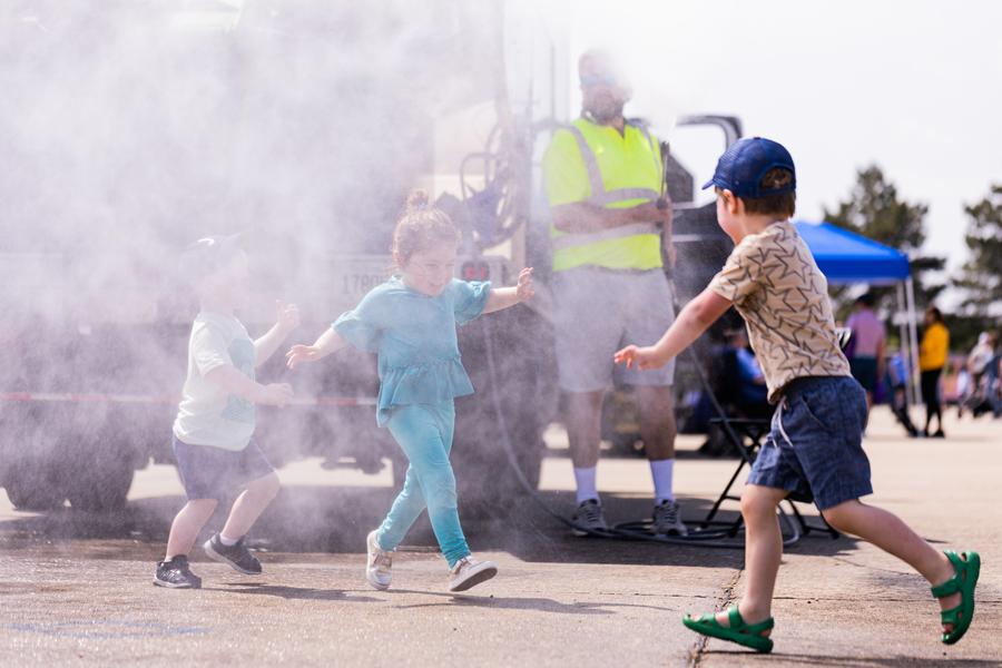 Children Running Towards Trucks at Kohl Children's Museum's Touch a Truck Event